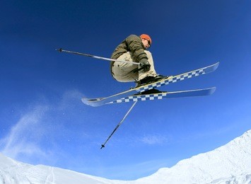 jumping skier on blue sky background