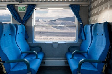 window train with snow landscape and empty seats.