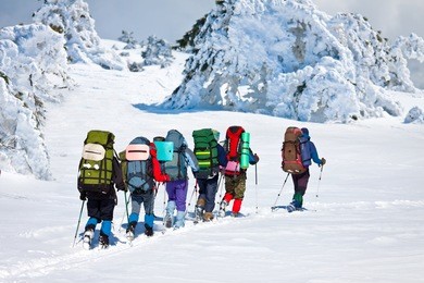 group of hikers in winter mountains