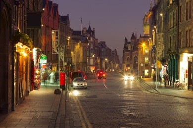 evening city life in the centre of edinburgh. the royal mile is a succession of streets which form the main thoroughfare of the old town of the city of edinburgh in scotland.