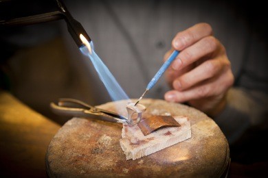 goldsmith working with a unfinished ring