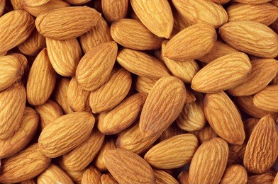 pile of almonds close-up as background.
