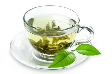 cup with green tea and green leaves.
