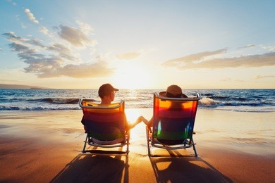 happy romantic couple enjoying beautiful sunset at the beach