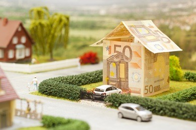 a euro bill house in a green neighborhood scenery