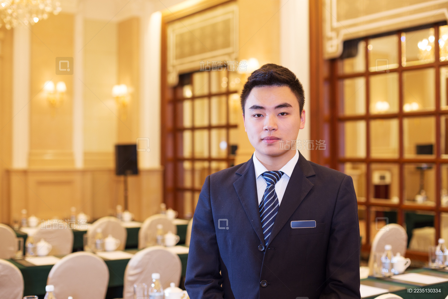 young chinese waiter service in dining room