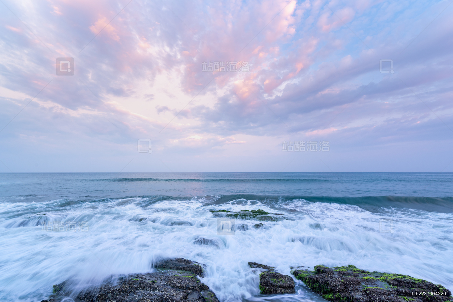 海岸边的浪花礁石和天空的美丽晚霞