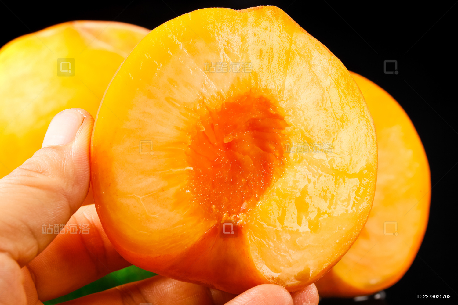 手上拿着一个切开的黄心黄桃