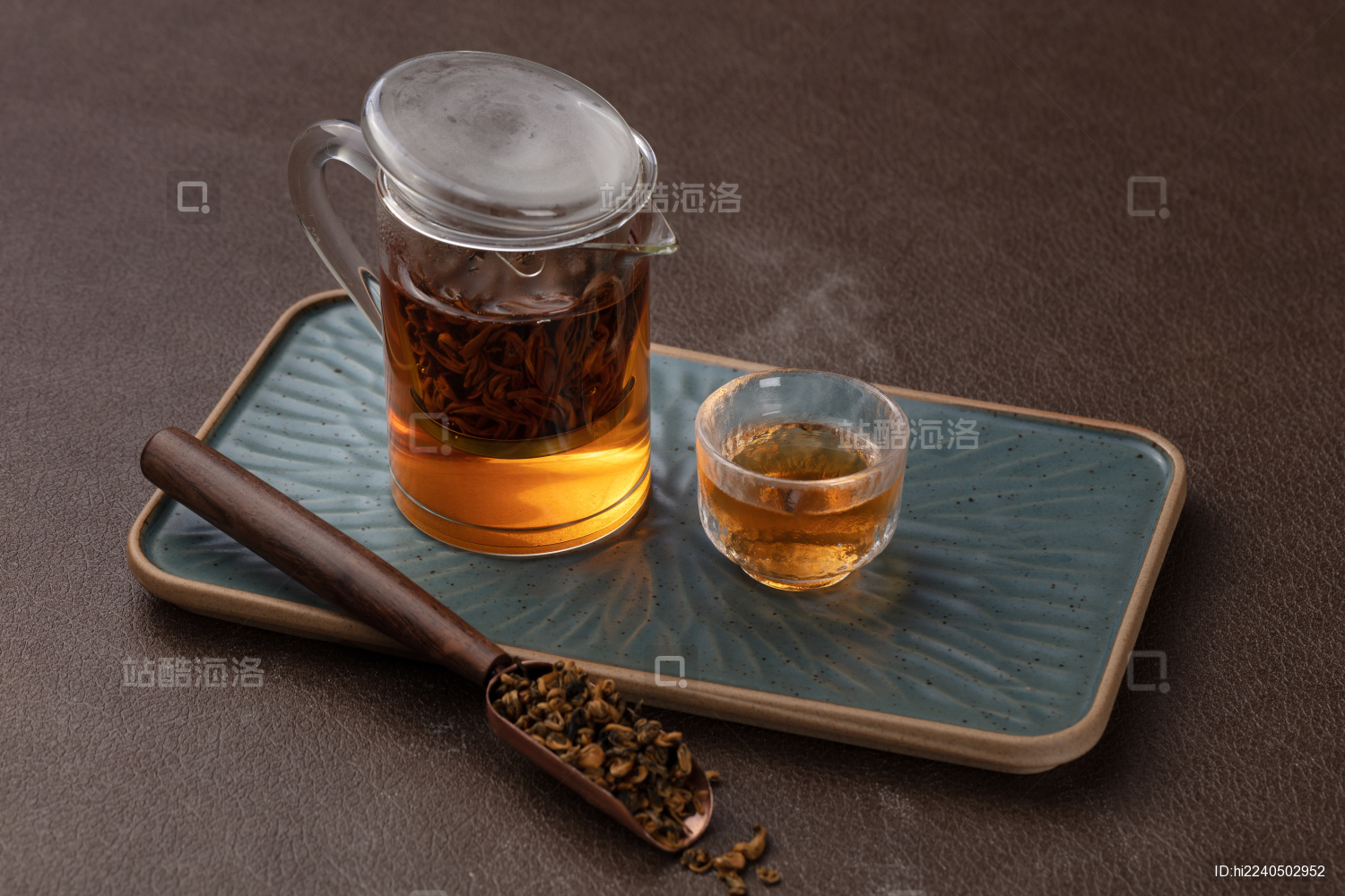 棕色桌子上古典托盘上玻璃茶壶正在泡红茶