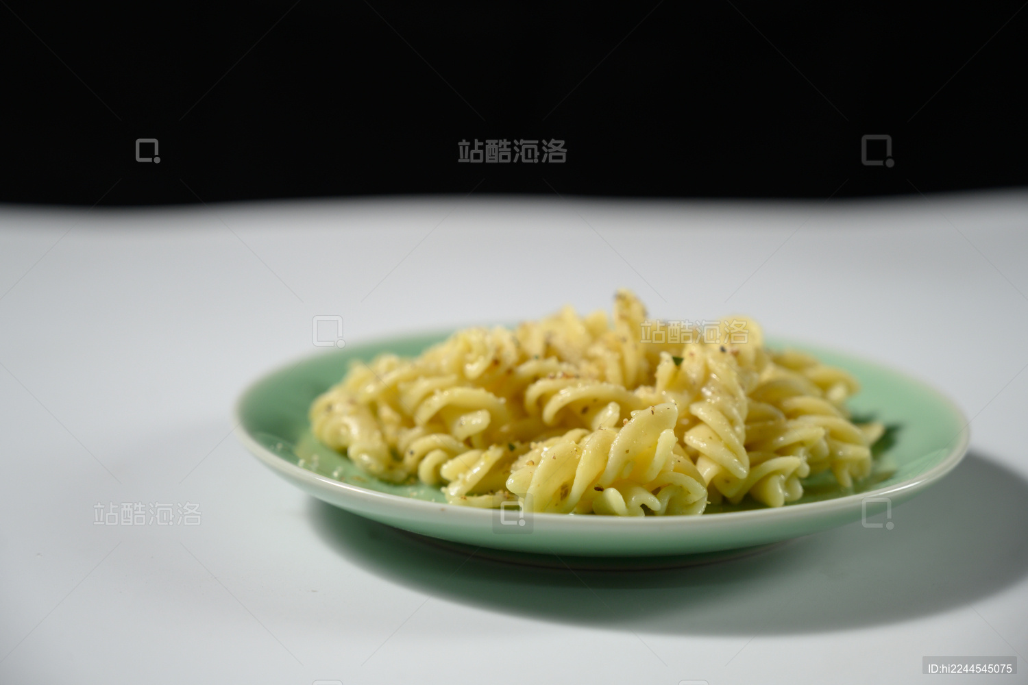 桌面上的盘子里的美味可口的青酱螺丝粉