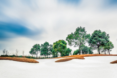 Sand bunker on golf course, landscape view