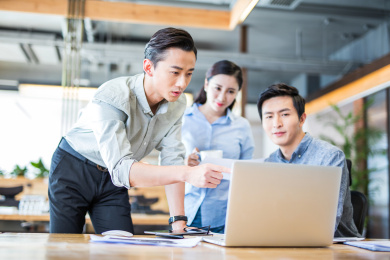 商务人士在电脑前讨论工作