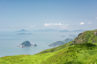 蓝天白云下的岛屿湖泊与绿油油的草场