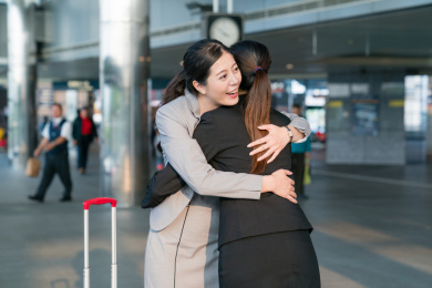 两个朋友在车站拥抱快乐会议。