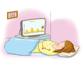 生病的女子躺在病床上看仪器数据