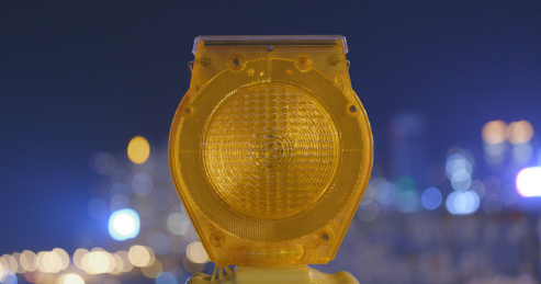 safety caution yellow light in the city at night