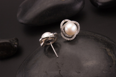 珍珠银饰耳环放在黑色的背景中