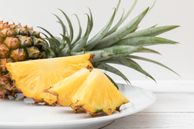 白色碟子上切开的热带水果金钻凤梨（无眼菠萝)