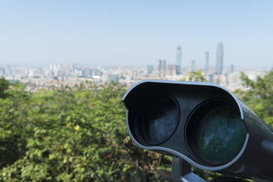 中国广西南宁青秀山夏天观景台上的望远镜和远处的城市