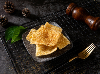 深色背景下放在盘子里的小米锅巴