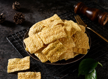 深色背景下放在盘子里的小米锅巴