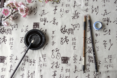 书法文章纸张上放着文房四宝和茶具