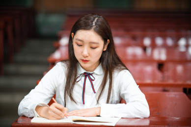 一个中国女学生,在教室内进行着自习与学习,认真的备考