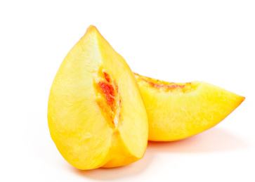 两个黄桃果瓣放在白底上