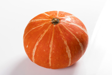 带有黄色花纹的橘红色南瓜摆放在桌面上