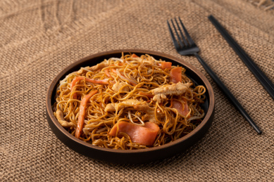 粗麻布上的盘子，盘子里的三丝炒面