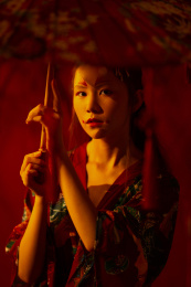 身穿汉服的女生手里拿着一把红伞的正面肖像