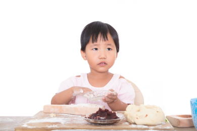 黄皮肤小女孩在制作中国传统节日中秋的月饼