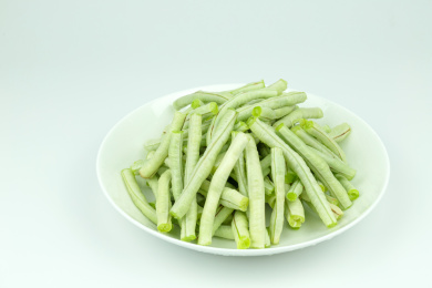 白色圆盘子里的新鲜绿色蔬菜豇豆