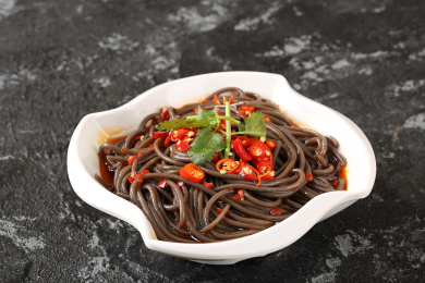 白色圆盘里的川菜凉菜红油凉拌小米椒蕨根粉