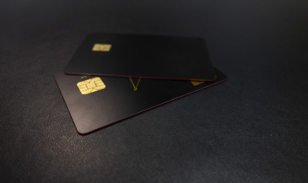 黑色背景中放着两张黑色的银行卡