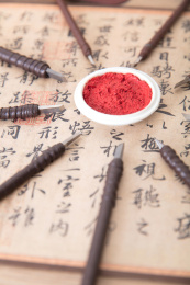 书法作品上大量钢制刻刀围绕着一盒印泥