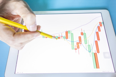 手里拿着笔在分析数据图表