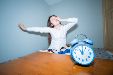 一个中国女孩早上起不来床赖床伸懒腰概念