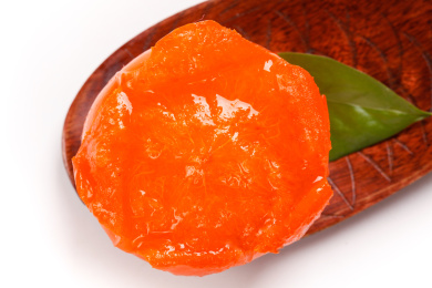 白底木勺上的一小坨水晶柿子果肉