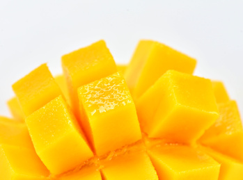 纯白背景下金黄色的新鲜芒果切片