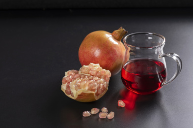 成熟的石榴和石榴籽石榴汁摆放在桌面上