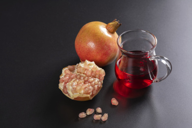 成熟的石榴和石榴籽石榴汁摆放在桌面上