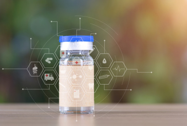 虚化的绿植背景前一瓶疫苗药品