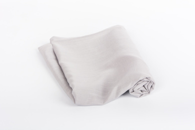 白色背景下中性灰纯色成卷棉麻布匹