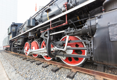 户外红黑涂装的老式蒸汽火车的驱动轮