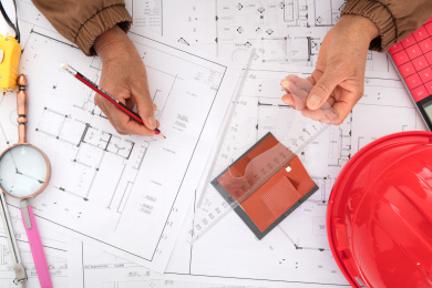 建筑行业从业者在对着大量图纸工作