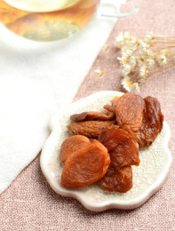 浅色背景上餐具里摆放的风干杏肉