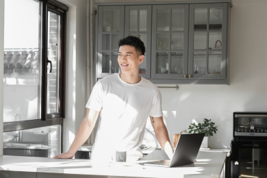 一个中国年轻男子在厨房喝咖啡