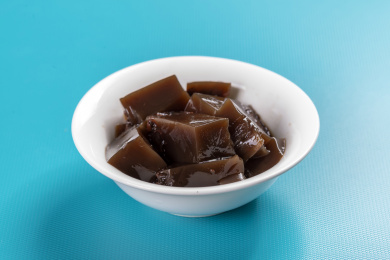 保健食品龟苓膏摆放在桌面上旁边有玉龟雕件