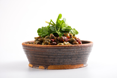 复古碗装着一大碗麻辣螺丝放在白色背景上